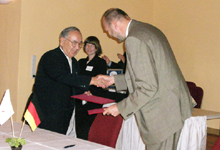 調印式で固い握手を交わすオラフ・ラッシュケ市長と岩永正太町長